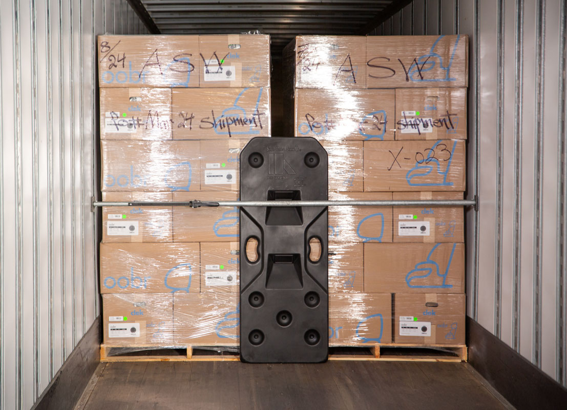 Freight Brace placed between two pallets, secured with a load bar