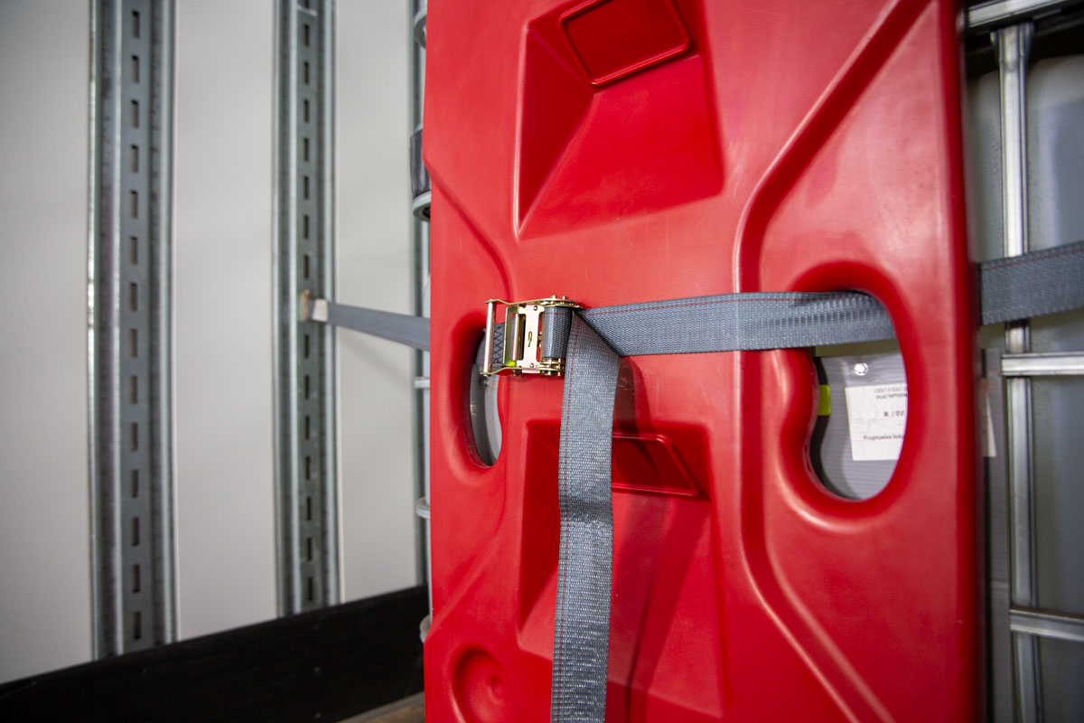 Close up of Freight Brace being installed with straps against a super sack