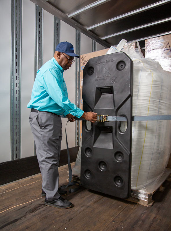 Freight Brace being installed with straps against a super sack